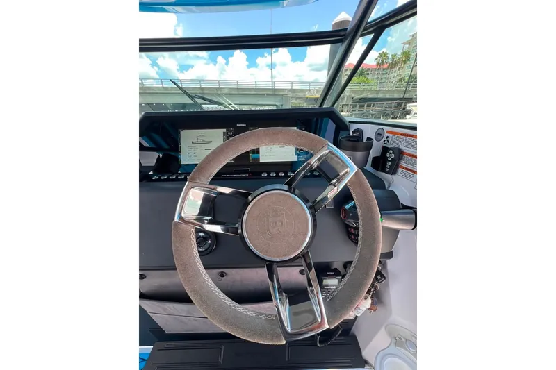 Slide: The Image of 2023 Axopar Brabus 37 Sun-Top steering wheel and dashboard view. - 21