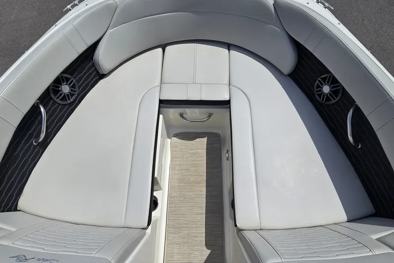 Slide: The Image of 2023 Sea Ray SPX 230 boat interior with white cushioned seating and built-in speakers. - 7