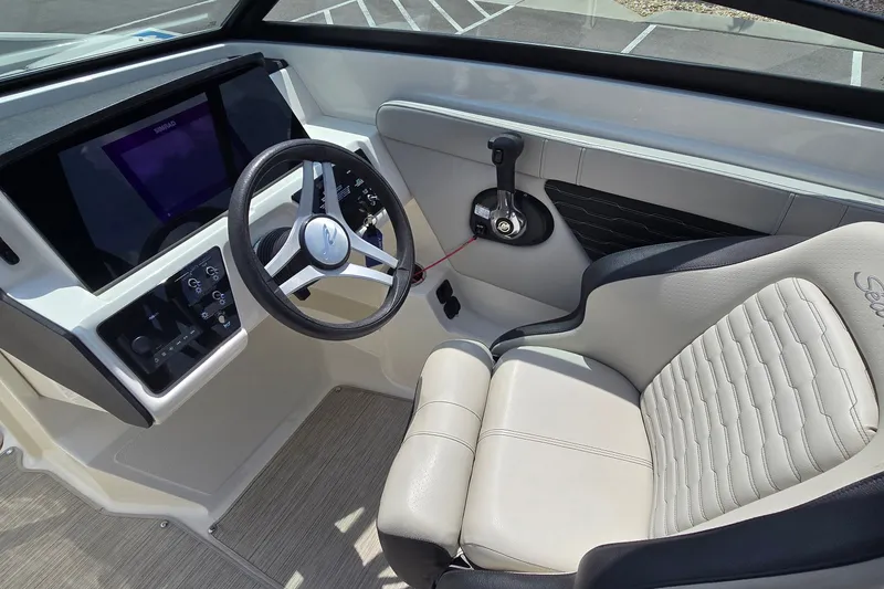 Slide: The Image of Interior of 2023 Sea Ray SPX 230 boat, featuring steering wheel and control panel. - 9