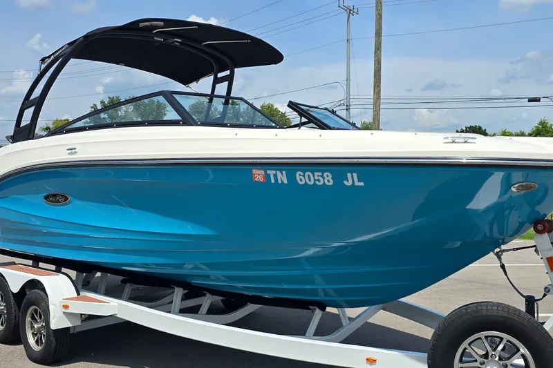Slide: The Image of 2023 Sea Ray SPX 230 boat on trailer, featuring sleek blue and white design. - 3