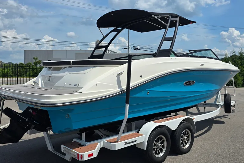 Slide: The Image of 2023 Sea Ray SPX 230 boat on trailer, featuring sleek design and vibrant blue hull. - 5