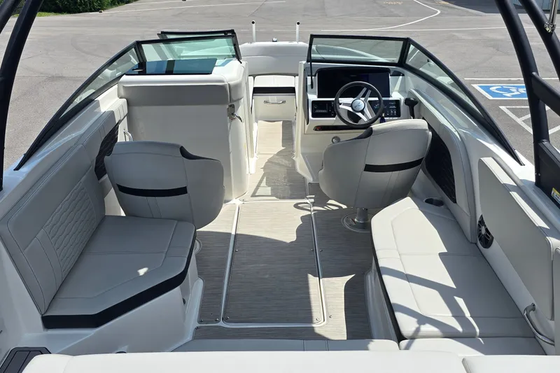 Slide: The Image of 2023 Sea Ray SPX 230 boat interior with modern seating and steering console. - 6