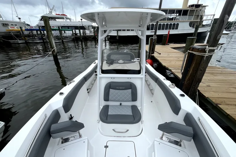 Slide: The Image of 2024 NauticStar 222L Offshore boat docked, showcasing sleek seating and modern design. - 4