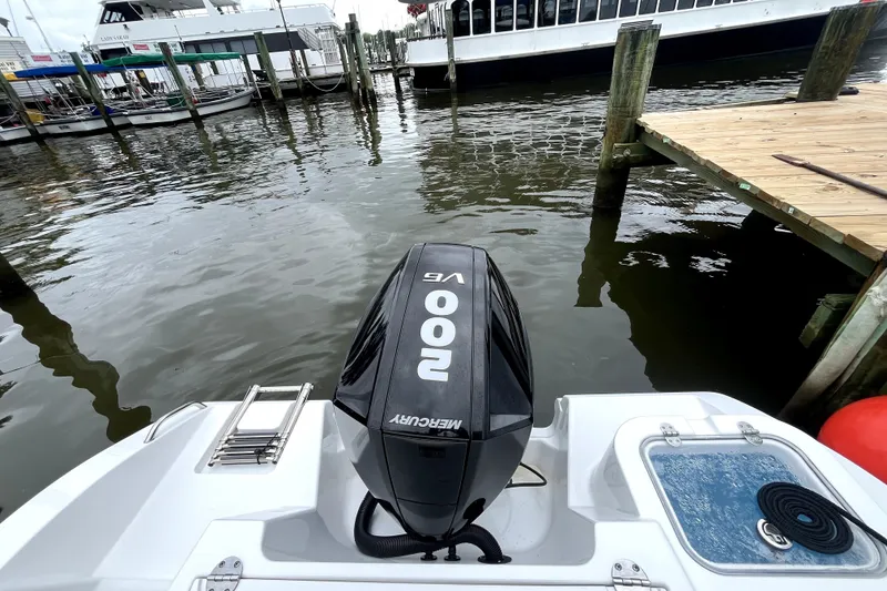 Slide: The Image of 2024 NauticStar 222L Offshore boat with Mercury 200 engine at dockside. - 9