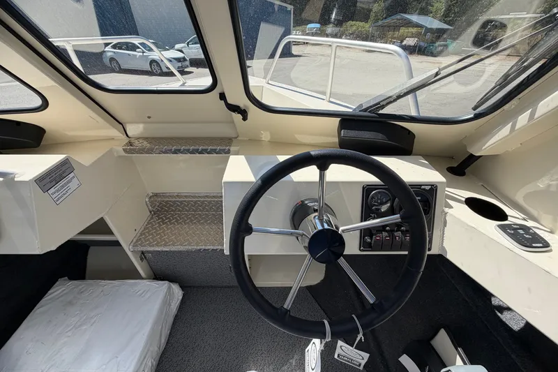 Slide: The Image of Interior view of 2026 Hewescraft 200 ProV ET Hardtop boat cockpit with steering wheel and controls. - 7