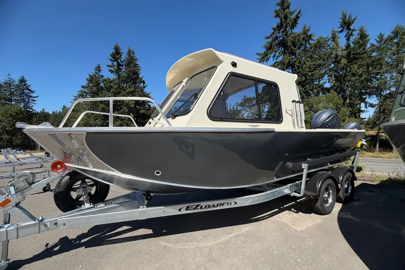 Slide: The Image of 2026 Hewescraft 200 ProV ET Hardtop boat on trailer, surrounded by trees. - 3