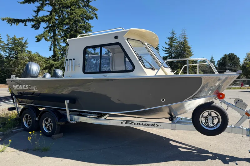 The Image of 2026 Hewescraft 200 ProV ET Hardtop boat on trailer, parked outdoors. - 1