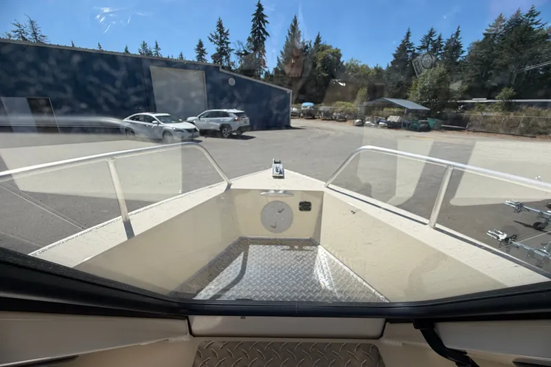 Slide: The Image of 2026 Hewescraft 200 ProV ET Hardtop boat interior view at a marina. - 12