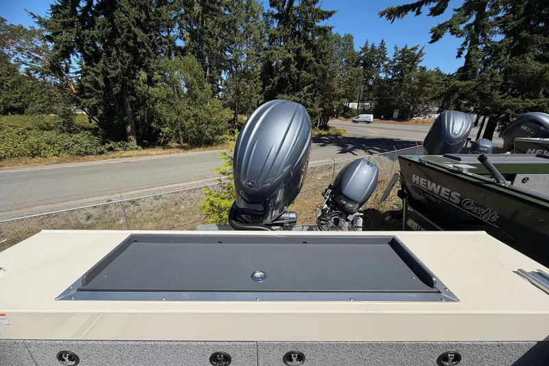Slide: The Image of 2026 Hewescraft 200 ProV ET Hardtop boat with outboard motor, parked near trees. - 9