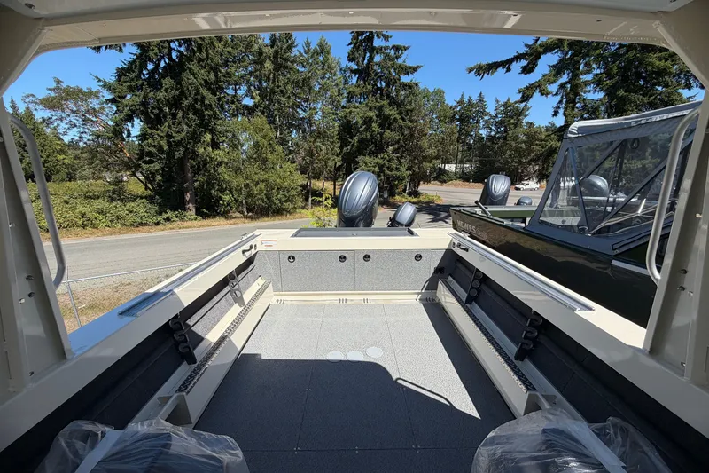Slide: The Image of 2026 Hewescraft 200 ProV ET Hardtop boat interior with spacious deck and scenic forest backdrop. - 8