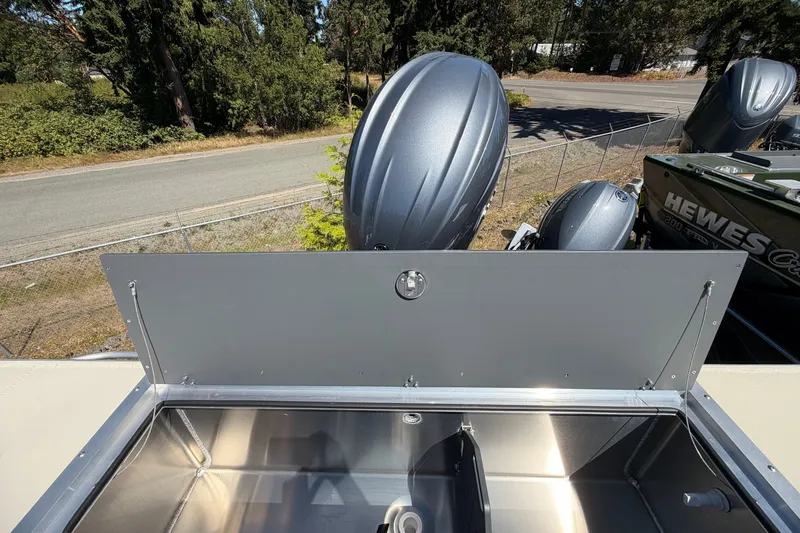 Slide: The Image of 2026 Hewescraft 200 ProV ET Hardtop boat with open storage compartment and outboard motor. - 11