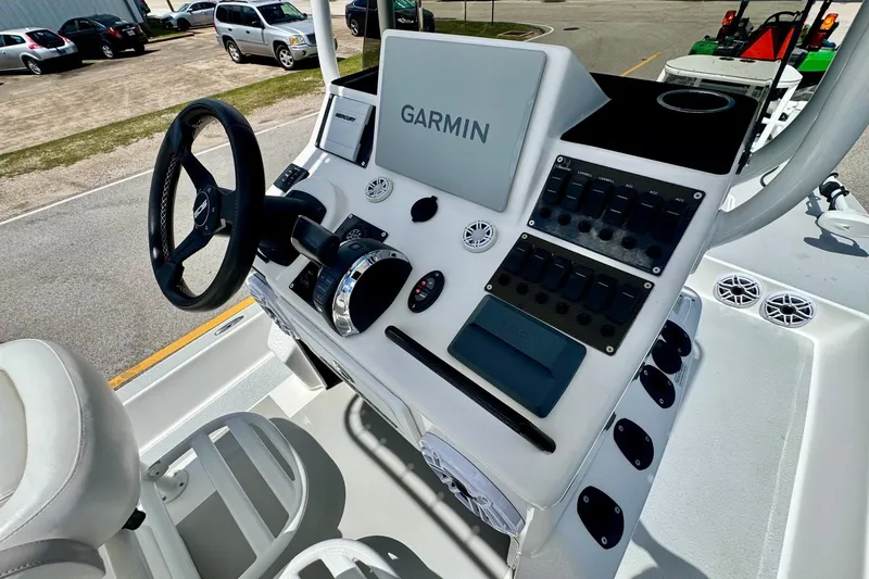 Slide: The Image of Boat console with Garmin navigation, steering wheel, and control panel on a 2021 SCB R24. - 17