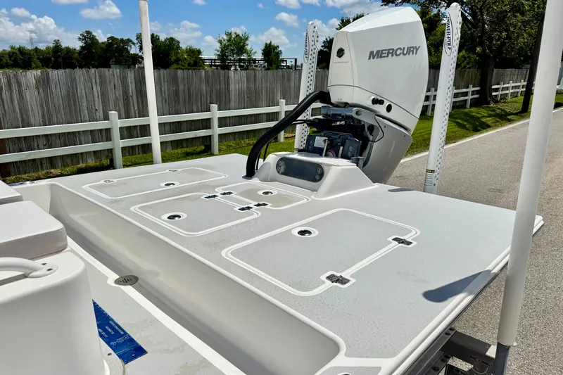 Slide: The Image of 2021 SCB R24 boat with Mercury engine, featuring a spacious deck and storage compartments. - 7