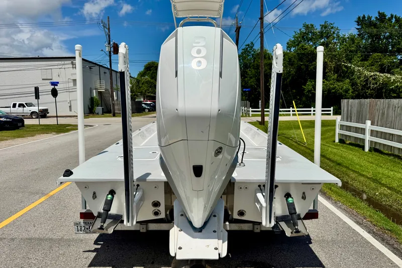 Slide: The Image of 2021 SCB R24 boat with powerful engine on trailer, parked on a sunny street. - 3