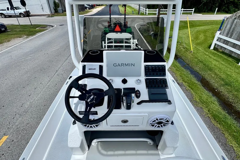Slide: The Image of 2021 SCB R24 boat console with Garmin navigation system and Mercury controls. - 12