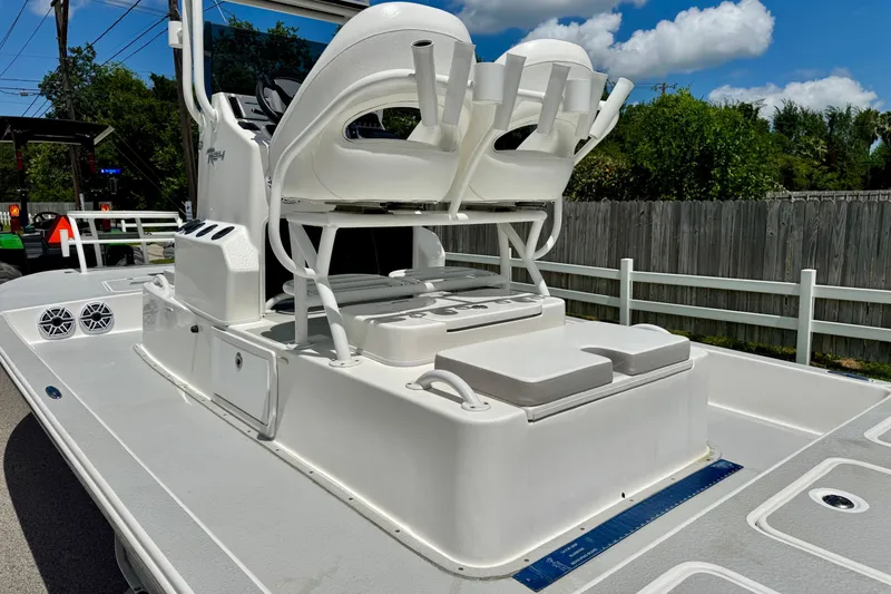Slide: The Image of 2021 SCB R24 boat deck with seating and storage, under a clear blue sky. - 8