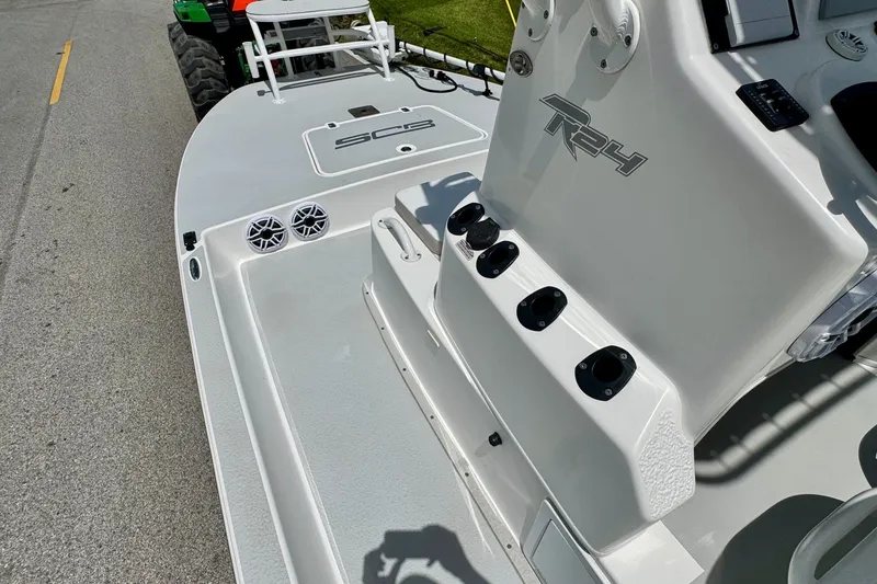 Slide: The Image of 2021 SCB R24 boat deck with speakers and control panel, parked on a road. - 13