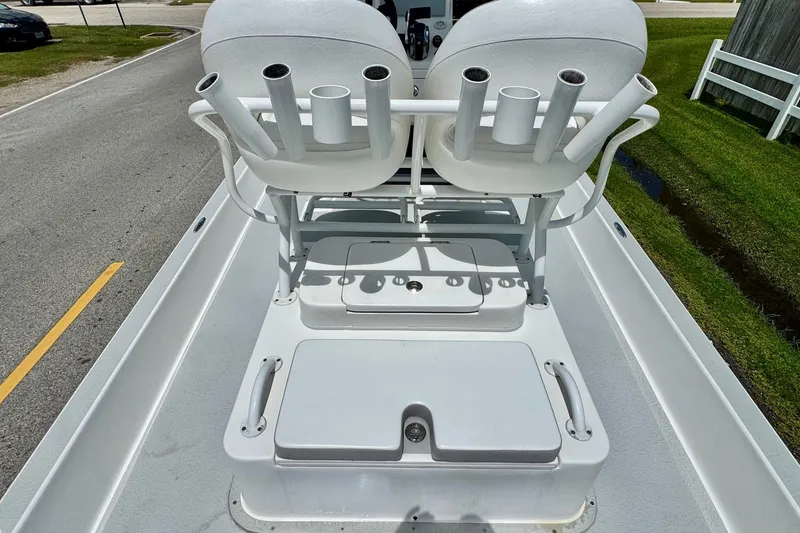 Slide: The Image of 2021 SCB R24 boat deck with rod holders and seating, parked on a road. - 9