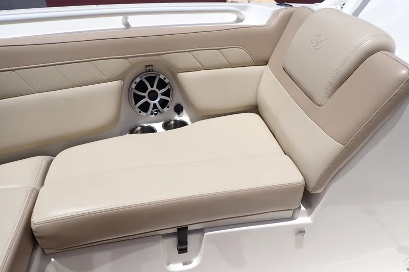 Slide: The Image of Luxurious seating on 2019 Sailfish 245 DC boat with integrated speaker and cup holders. - 45
