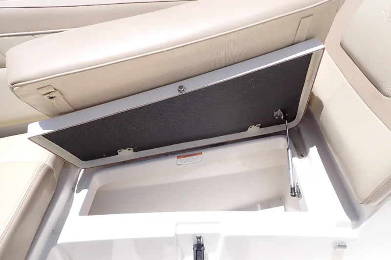 Slide: The Image of Open storage compartment in 2019 Sailfish 245 DC boat with beige seating. - 46