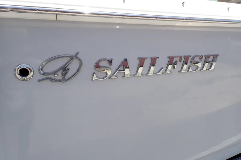 Slide: The Image of 2019 Sailfish 245 DC boat logo on sleek white hull. - 133