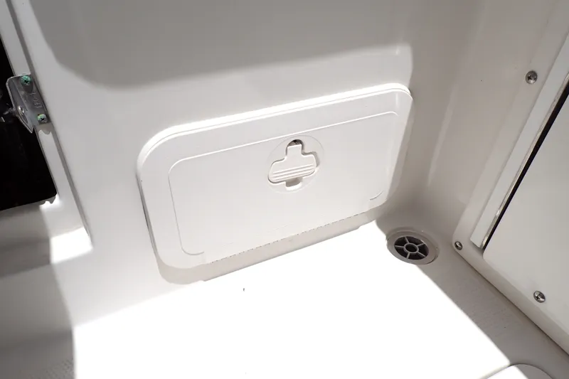 Slide: The Image of 2019 Sailfish 245 DC boat storage compartment with drain, showcasing interior design. - 75