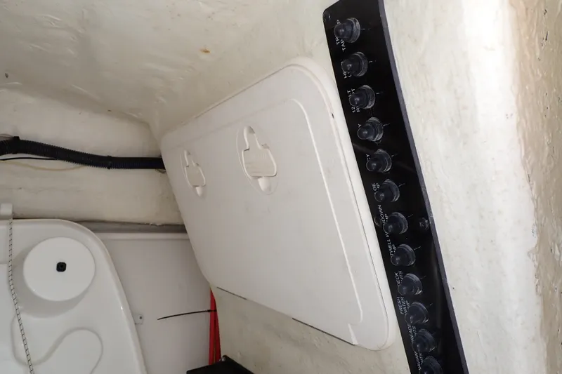 Slide: The Image of Control panel and storage compartment inside a 2019 Sailfish 245 DC boat. - 97