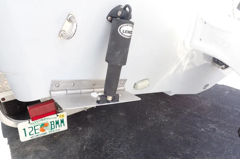 Slide: The Image of 2019 Sailfish 245 DC boat with Lenco trim tab and Florida license plate. - 110