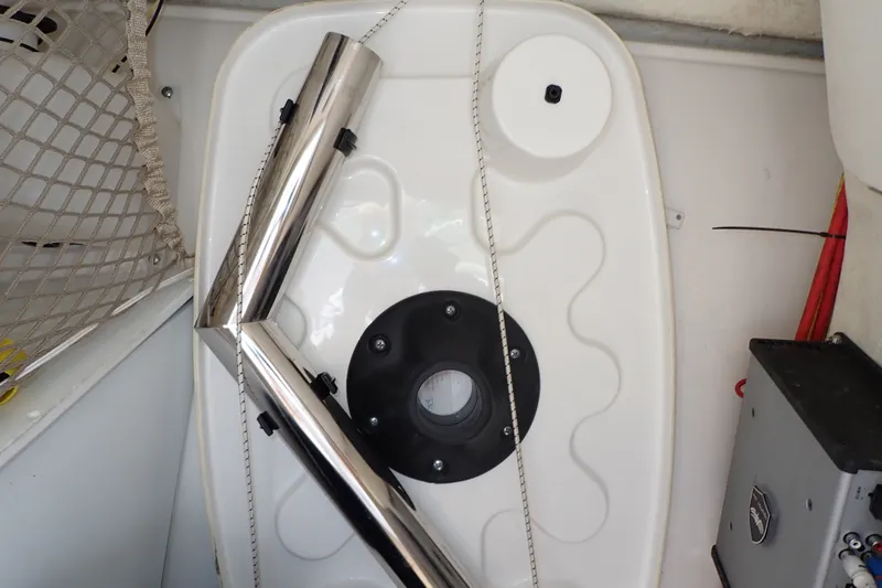 Slide: The Image of Storage compartment in a 2019 Sailfish 245 DC boat with stainless steel rods and netting. - 99