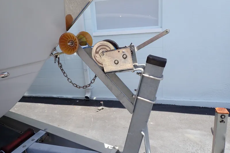 Slide: The Image of Boat trailer winch system on a 2019 Sailfish 245 DC, secured with chain and pulley. - 122