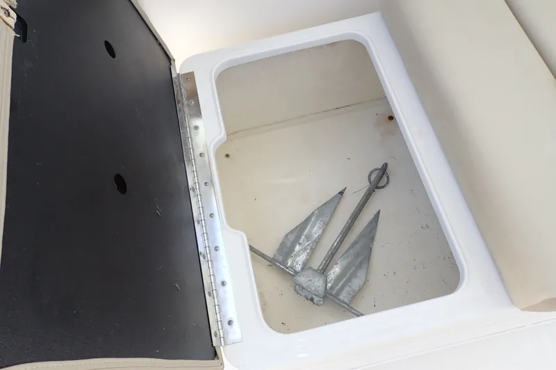 Slide: The Image of Open storage compartment with anchor in 2019 Sailfish 245 DC boat. - 60