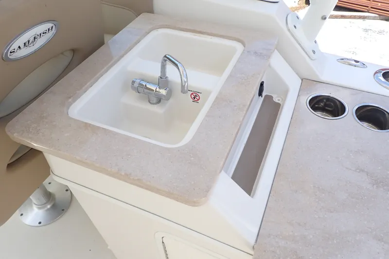 Slide: The Image of 2019 Sailfish 245 DC boat sink and countertop with integrated cup holders. - 14