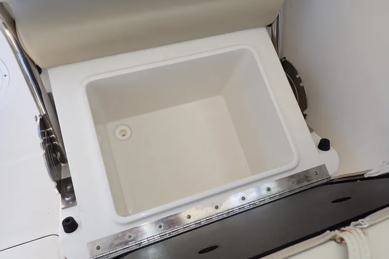 Slide: The Image of 2019 Sailfish 245 DC boat storage compartment with cushioned seat and stainless steel hardware. - 55