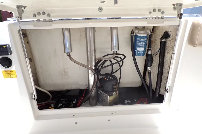 Slide: The Image of Open compartment of 2019 Sailfish 245 DC boat showing engine components and wiring. - 70