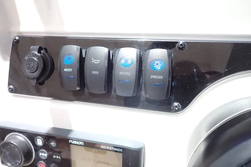 Slide: The Image of Control panel of a 2019 Sailfish 245 DC boat with switches and USB port. - 27