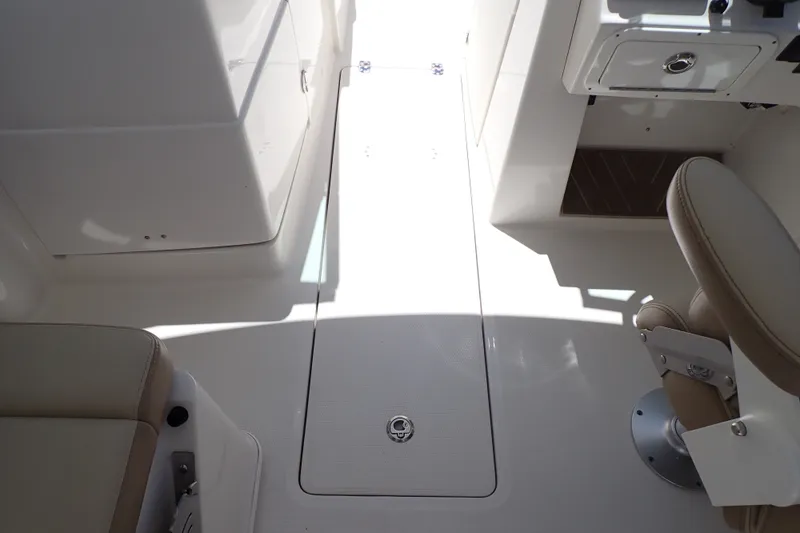 Slide: The Image of 2019 Sailfish 245 DC boat interior with seating and storage compartments. - 51
