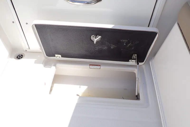 Slide: The Image of Open storage compartment on a 2019 Sailfish 245 DC boat, showcasing interior space. - 67