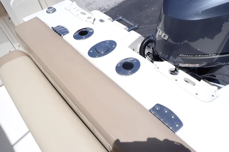 Slide: The Image of 2019 Sailfish 245 DC boat with beige seating and powerful outboard motor. - 30