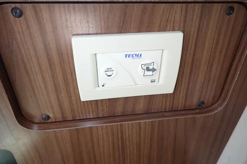 Slide: The Image of Control panel on 2019 Sailfish 245 DC boat, featuring Tecma Thetford flush system. - 34