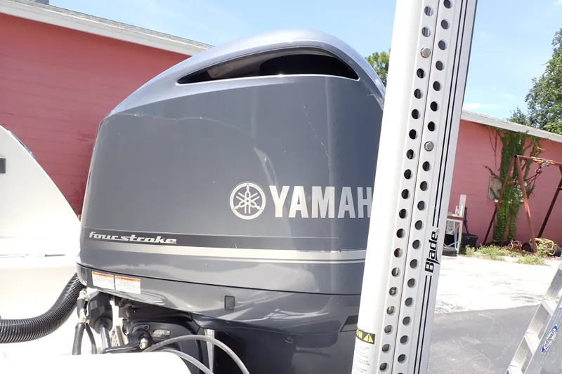 Slide: The Image of Yamaha four-stroke engine on 2019 Sailfish 245 DC boat, outdoor setting. - 107