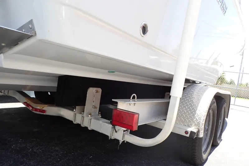 Slide: The Image of 2019 Sailfish 245 DC boat on trailer, rear view with dual axles. - 117