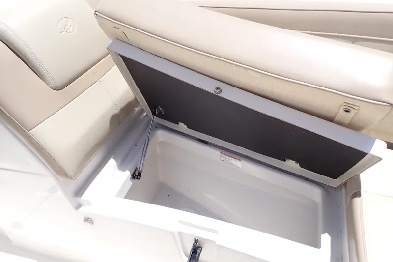 Slide: The Image of Open storage compartment in 2019 Sailfish 245 DC boat with beige seating. - 44