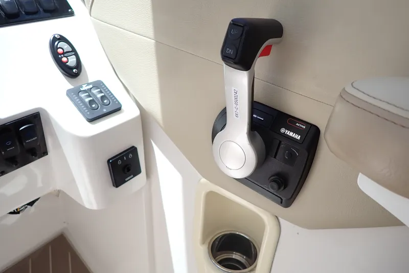 Slide: The Image of Control panel of a 2019 Sailfish 245 DC boat featuring Yamaha throttle. - 28