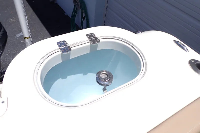 Slide: The Image of Livewell on 2019 Sailfish 245 DC boat, featuring stainless steel hinges and clear water. - 77