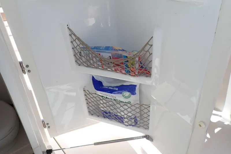 Slide: The Image of Storage compartments with netting on a 2019 Sailfish 245 DC boat. - 39