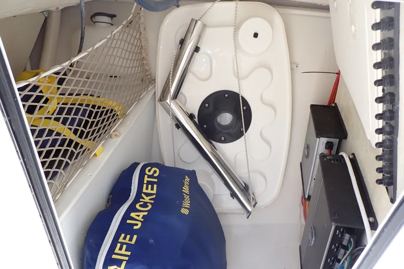 Slide: The Image of Storage compartment of a 2019 Sailfish 245 DC boat with life jackets and equipment. - 94