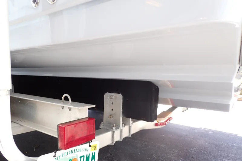 Slide: The Image of 2019 Sailfish 245 DC boat on trailer, rear view with Florida license plate. - 129
