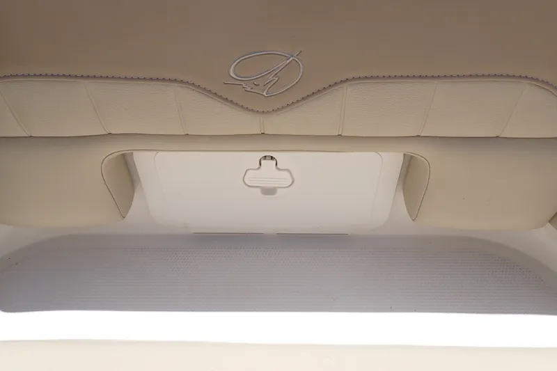 Slide: The Image of 2019 Sailfish 245 DC boat interior storage compartment with beige upholstery. - 49