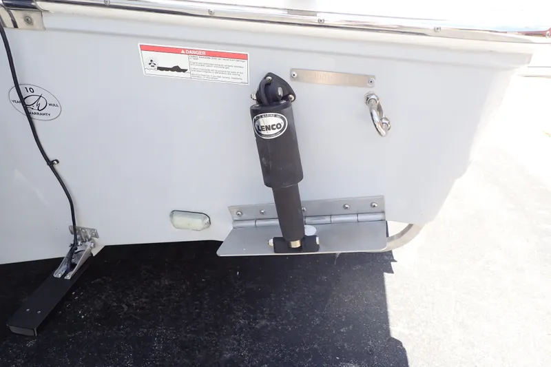 Slide: The Image of 2019 Sailfish 245 DC boat transom with Lenco trim tab and warranty sticker. - 116