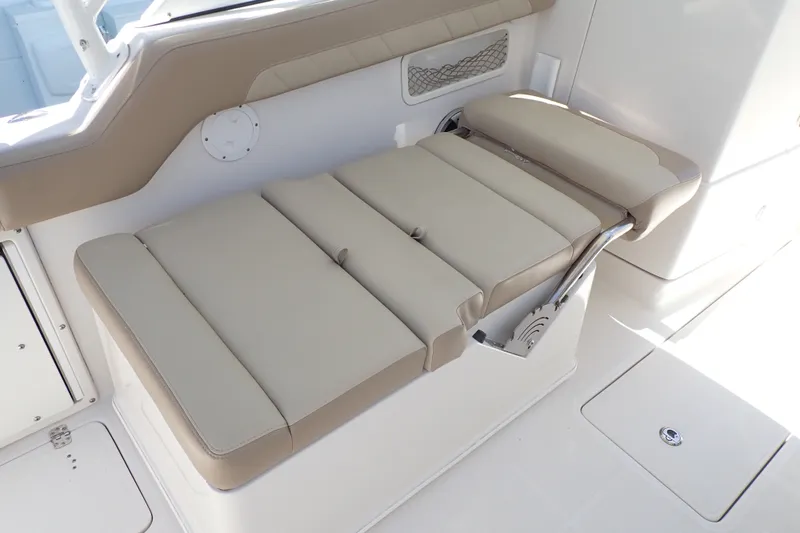 Slide: The Image of 2019 Sailfish 245 DC boat interior with beige cushioned seating. - 58